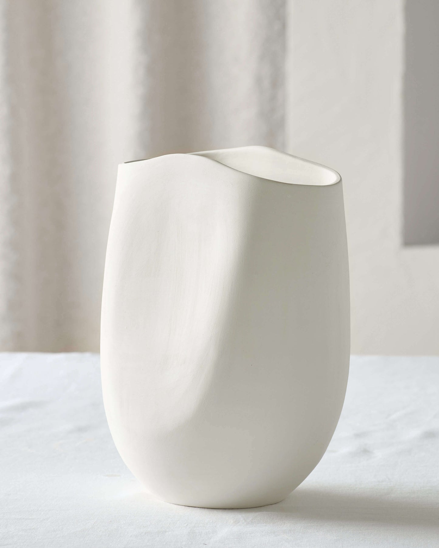 
                  
                    Medium Zoya Terracotta Vase in white with unique abstract design and textured finish.
                  
                