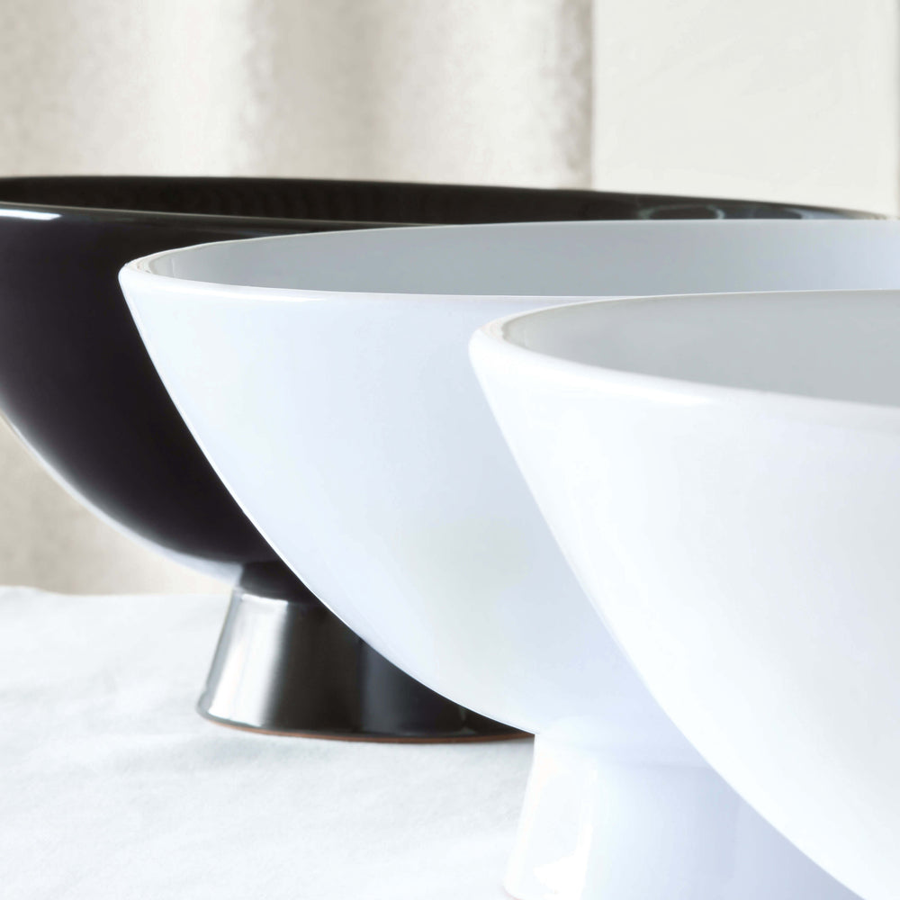 
                  
                    Close-up detail shot of Rami Pedestal Bowls in white, black and gray.
                  
                