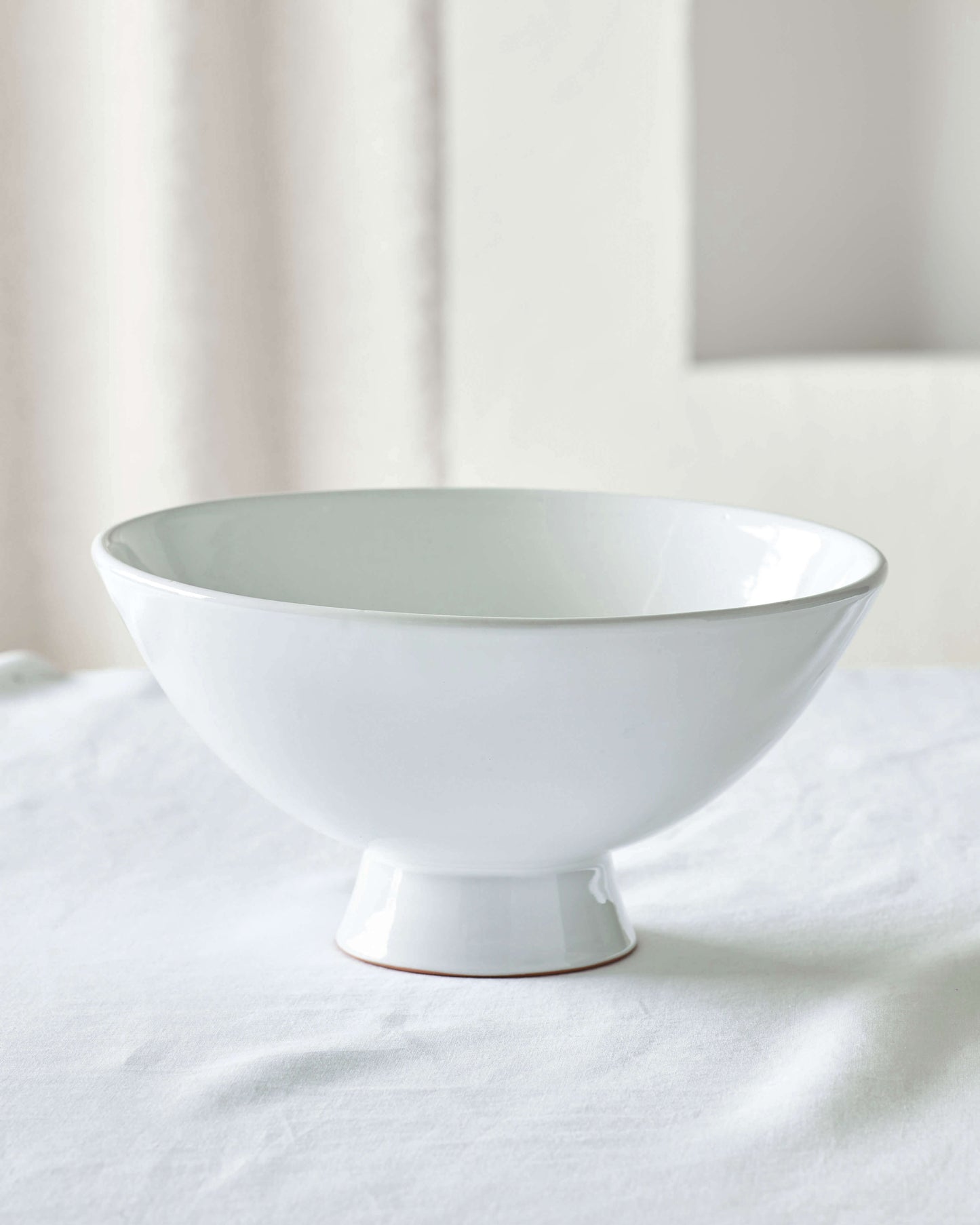 
                  
                    White glossy Rami Pedestal Bowl by Fairkind.
                  
                