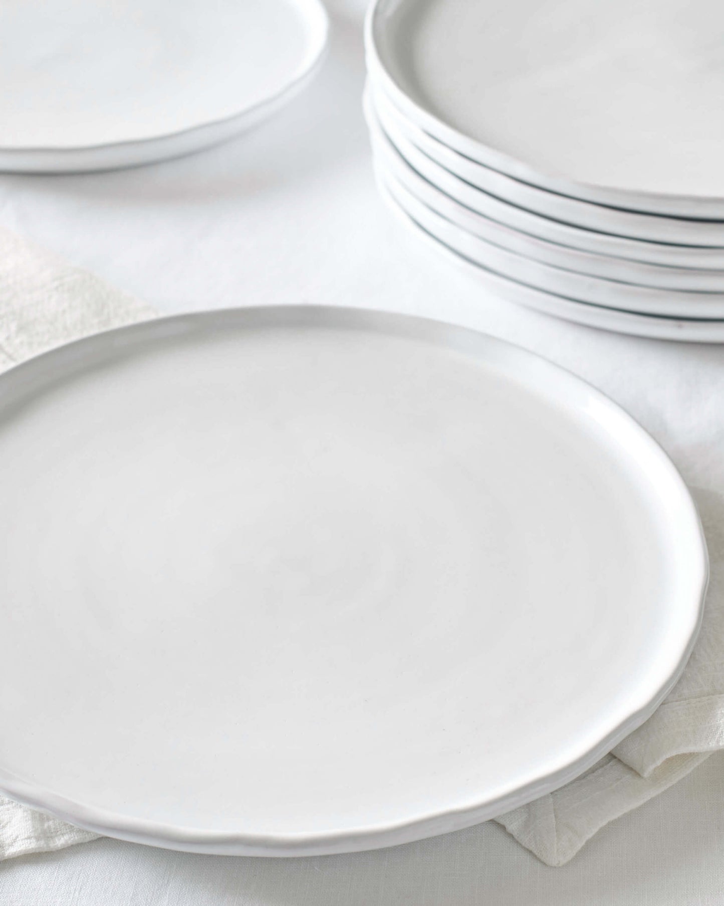 
                  
                    Khira ceramic dinner plates stacked against white background. Made by artisans in Morocco.
                  
                