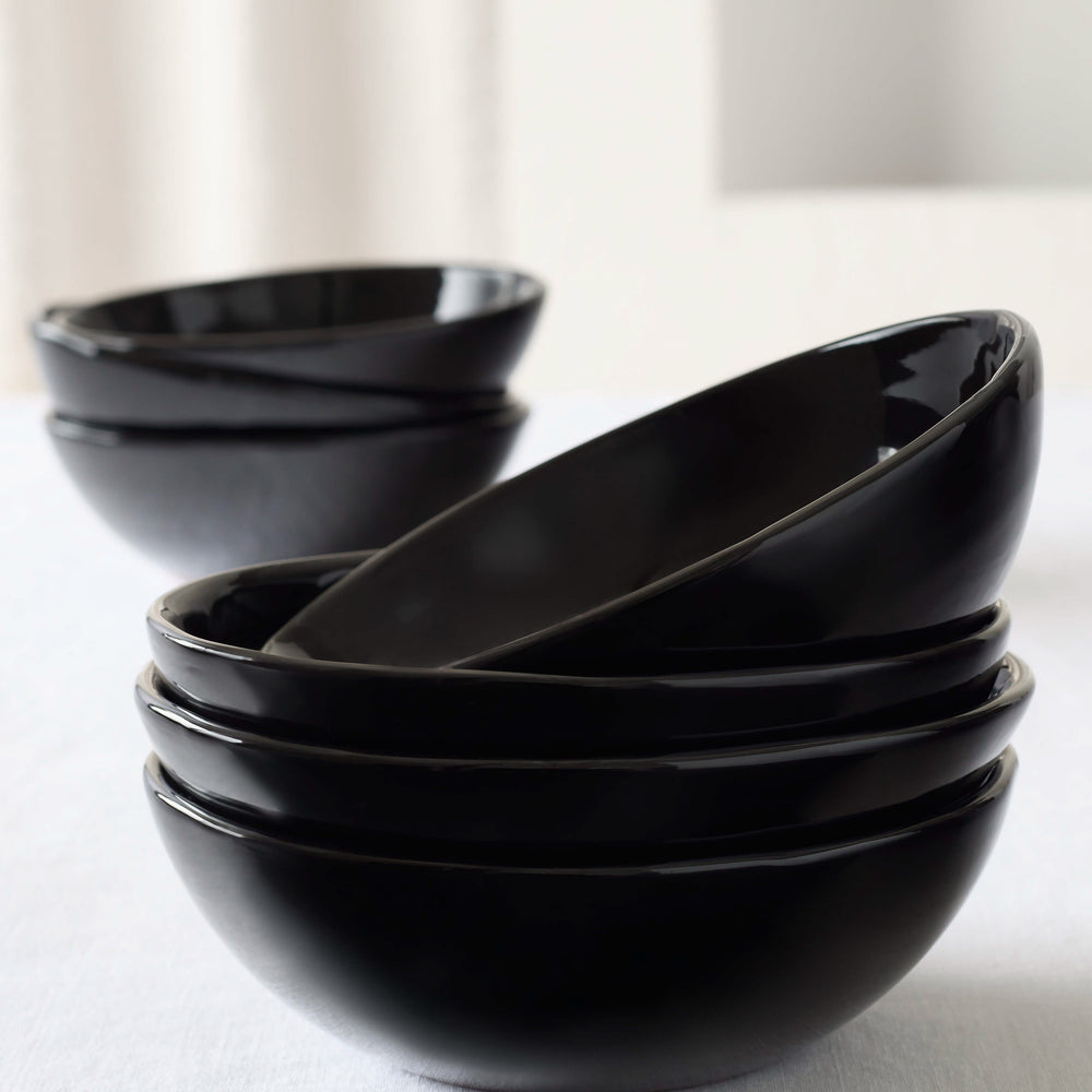 
                  
                    Black Riad Soup Bowls stacked on white table, part of the Morocco Ceramic Collection by Fairkind.
                  
                