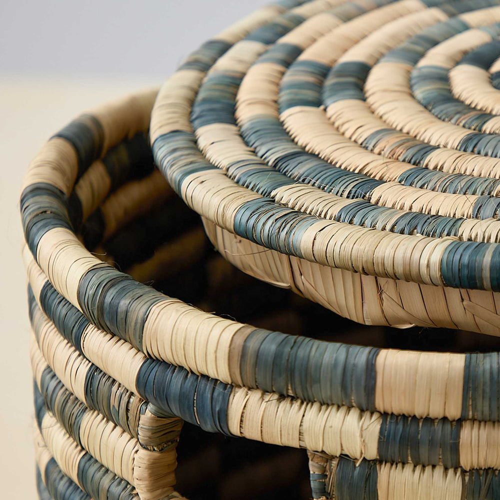 
                  
                    Detail of lidded Azibo Storage Basket by Fairkind. Charcoal and natural stripes, handwoven in Malawi.
                  
                