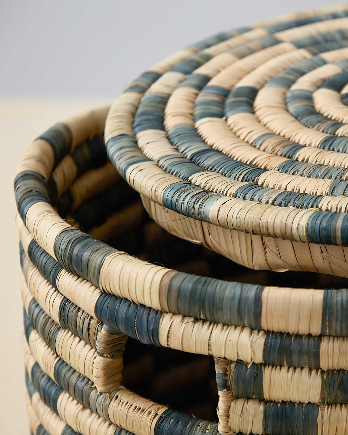 Detail of lidded Azibo Storage Basket by Fairkind. Charcoal and natural stripes, handwoven in Malawi.