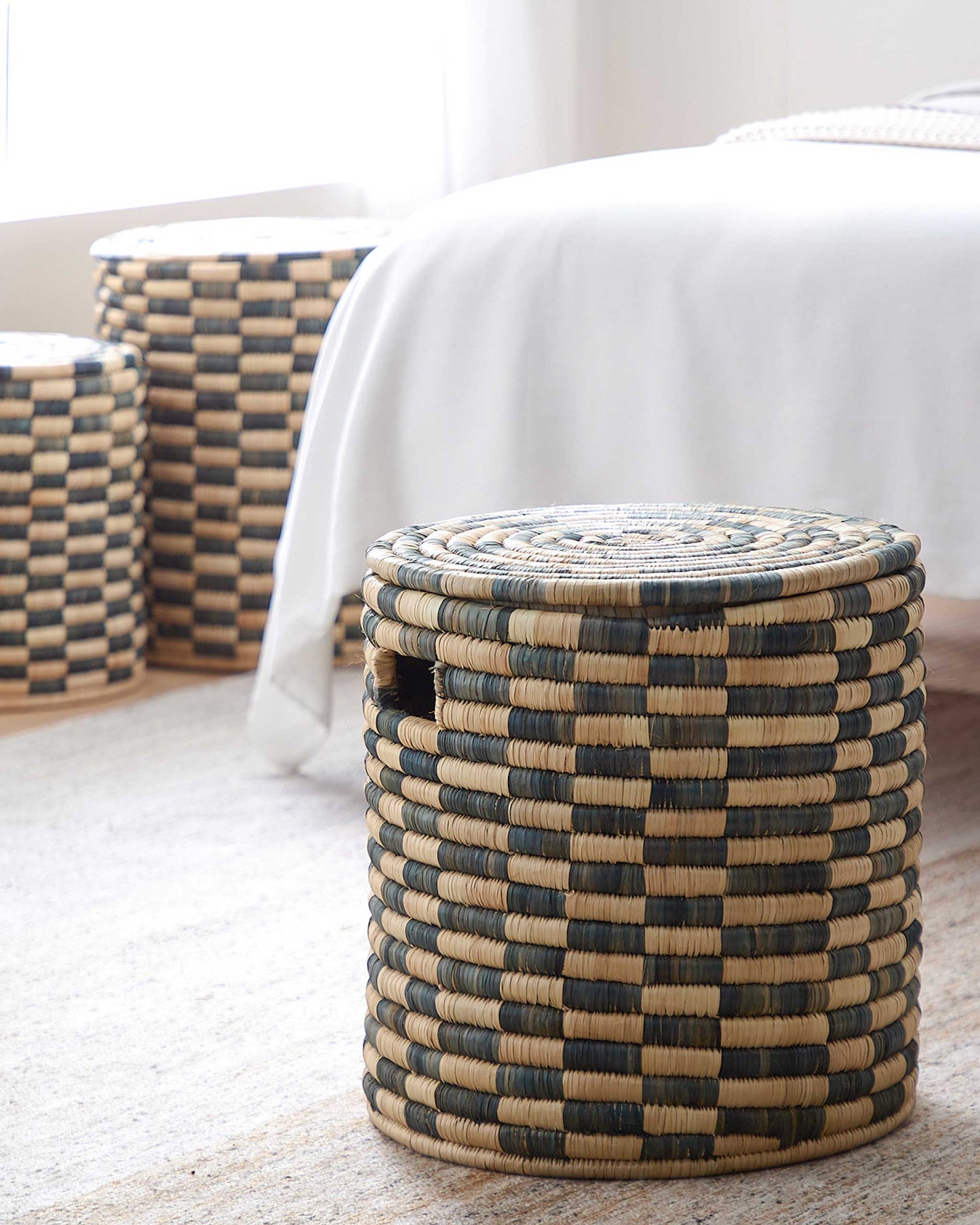 
                  
                    Handmade Azibo Baskets in modern bedroom. Malawi Collection by Fairkind.
                  
                