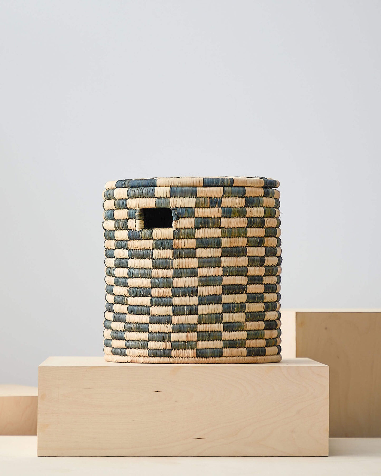 
                  
                    Small checkered lidded storage basket. Azibo Storage Baskets by Fairkind.
                  
                