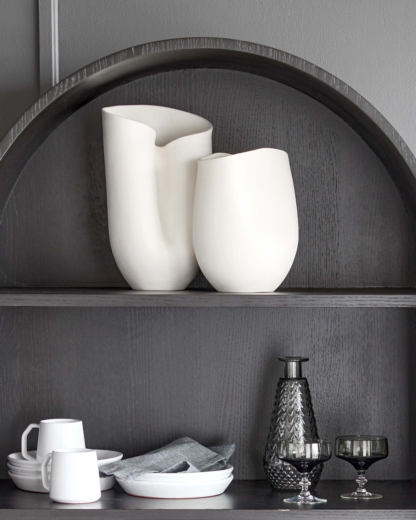 
                  
                    Large and Medium Zoya Vases styled on the top shelf of a modern black hutch. Part of Fairkind's Morocco Ceramic Collection.
                  
                