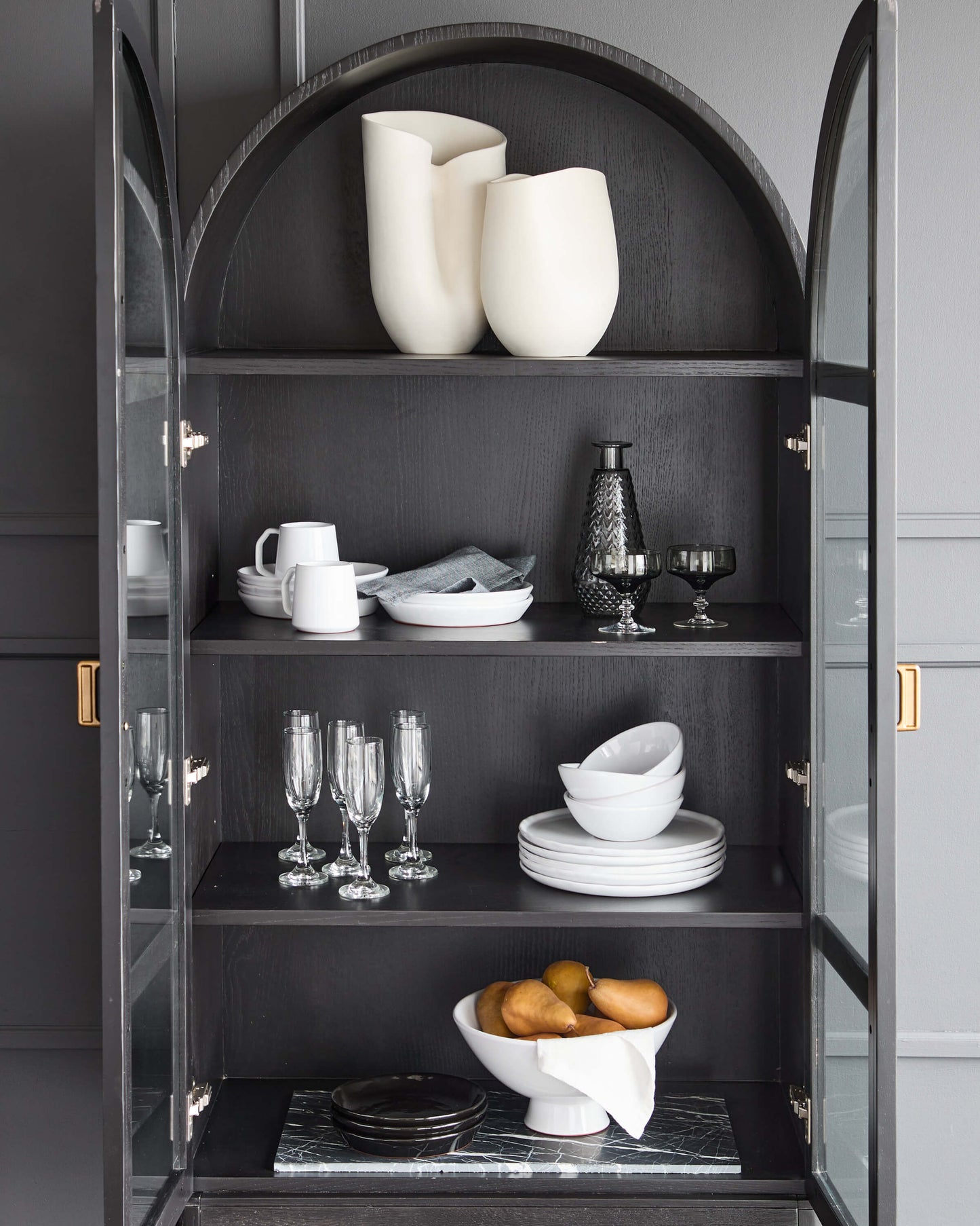 
                  
                    Handcrafted ceramics from Morocco in modern, black hutch.
                  
                