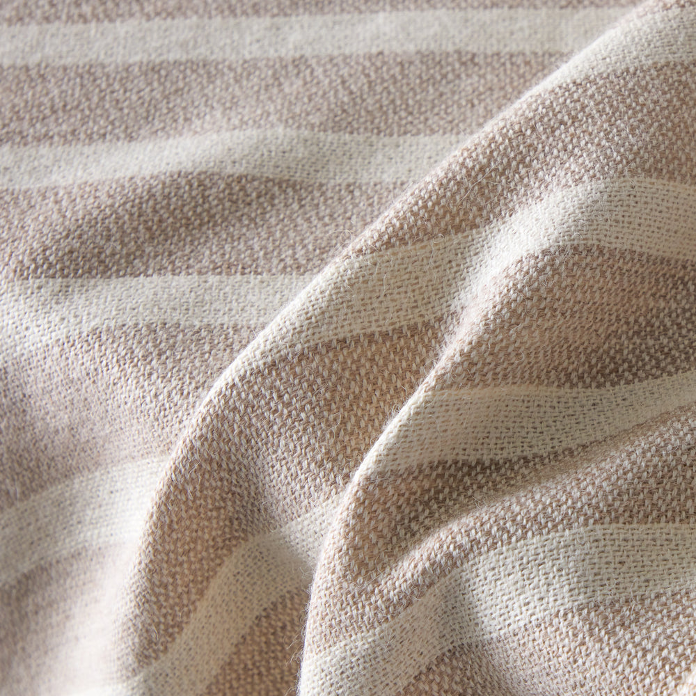 
                  
                    Detail of baby alpaca throw blanket sand with white stripes and fringe super soft and warm lightweight alpaca.
                  
                