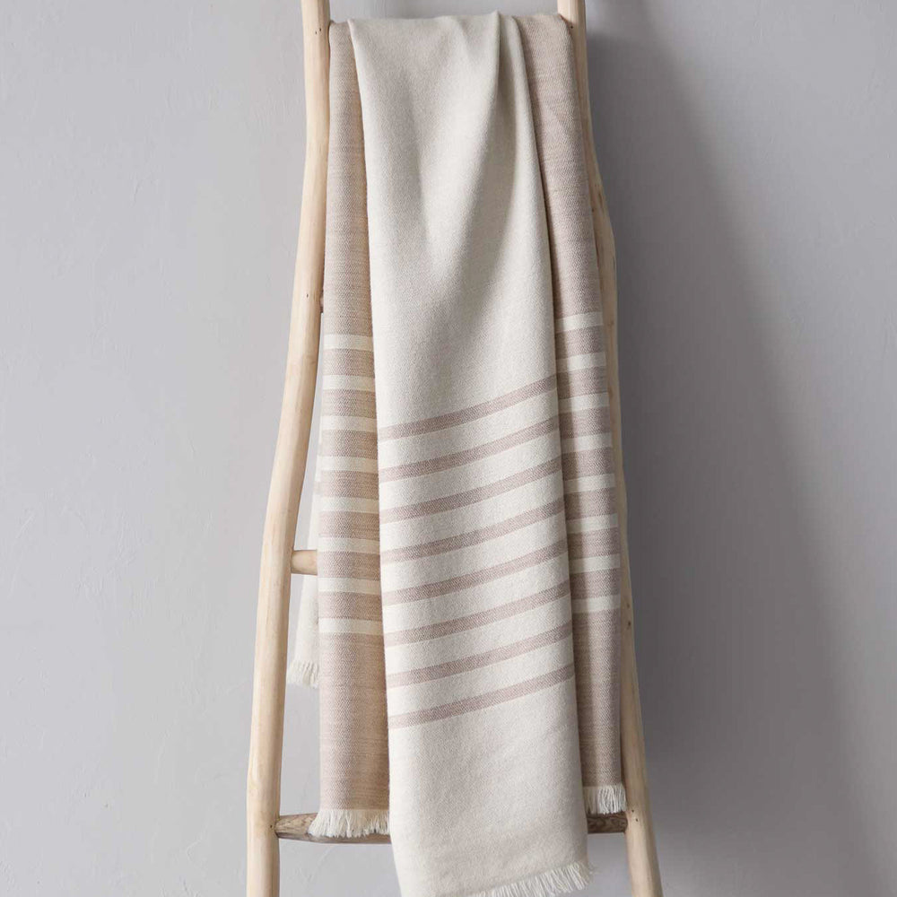 
                  
                    Sand colored luxury baby alpaca throw blanket by Fairkind ethically sourced and fair trade made in Peru.
                  
                