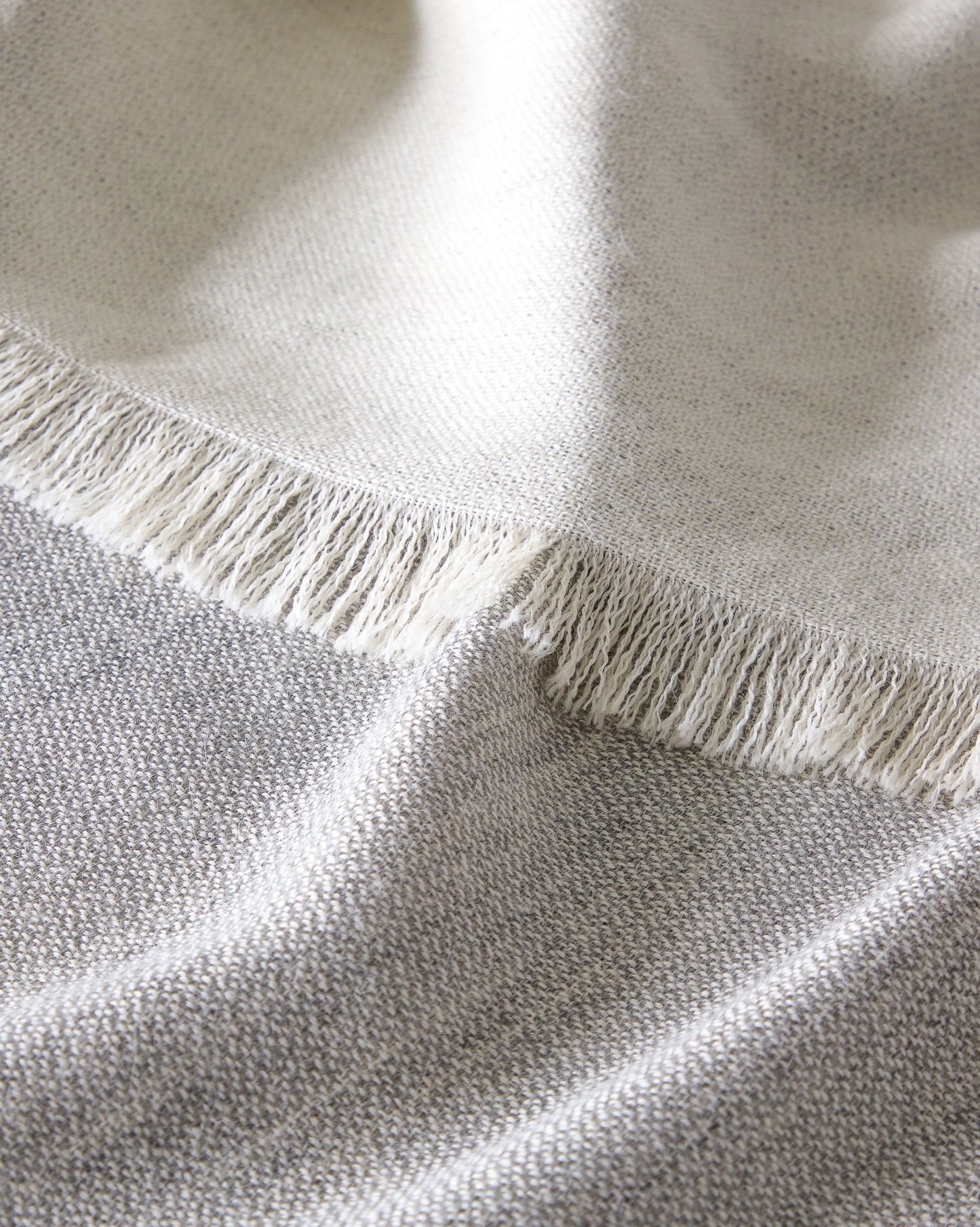 
                  
                    Fringe detail of Soñando gray handwoven baby alpaca throw ethically sourced and limited edition gift.
                  
                