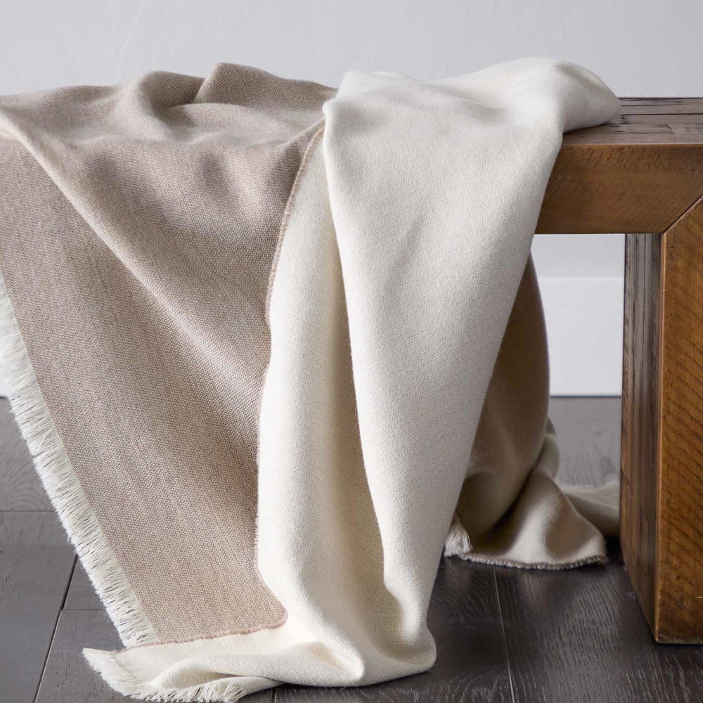 
                  
                    Styled beige tan and white luxury baby alpaca super soft blanket ethically sourced.
                  
                