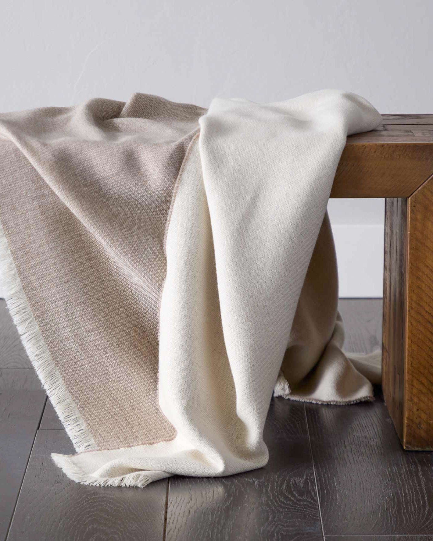 
                  
                    Styled beige tan and white luxury baby alpaca super soft blanket ethically sourced.
                  
                